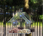 Window bird feeder filled with seed on a window