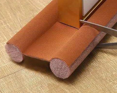Brown under-door draught excluder fitted to a door