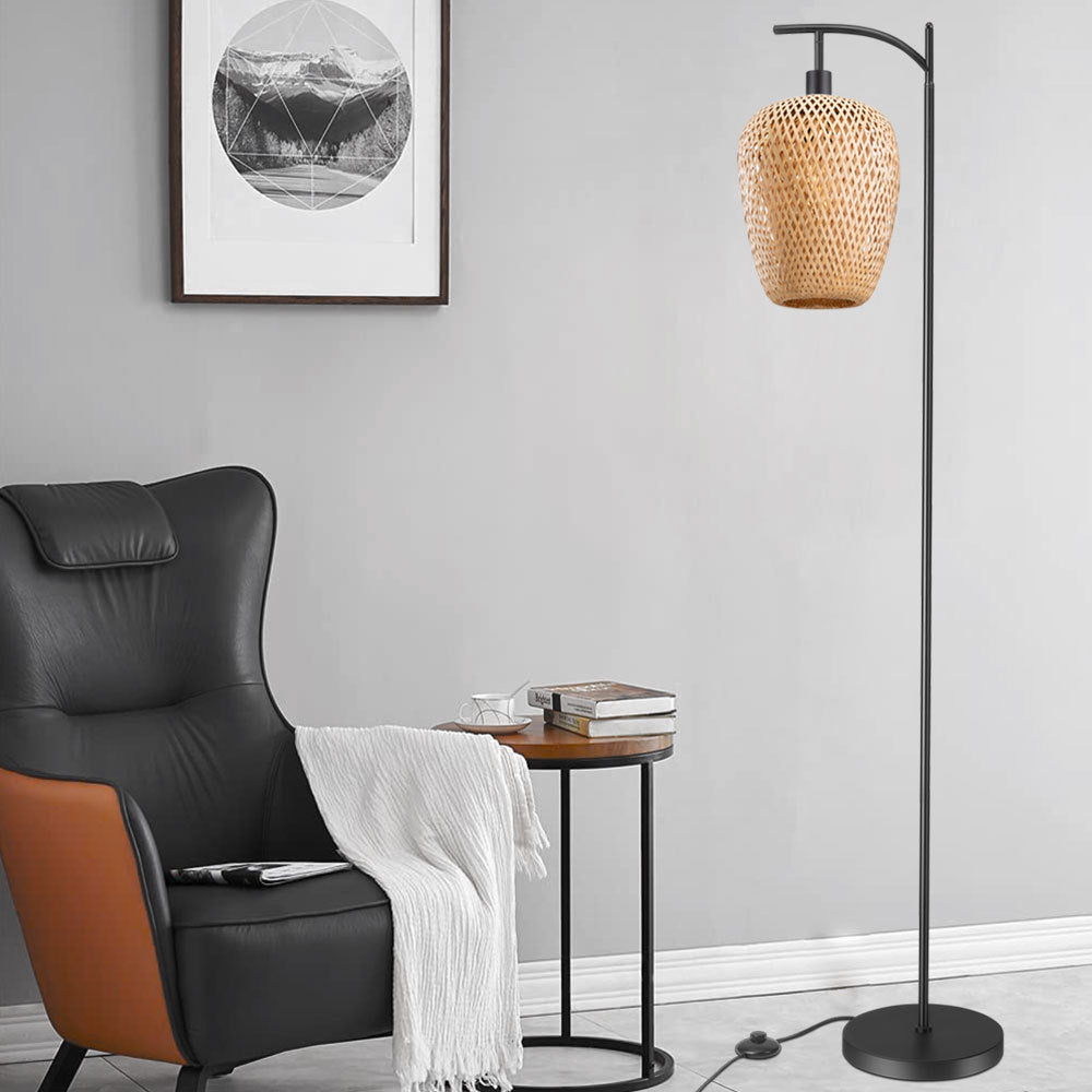 Black arc floor lamp with a hanging woven rattan-look shade
