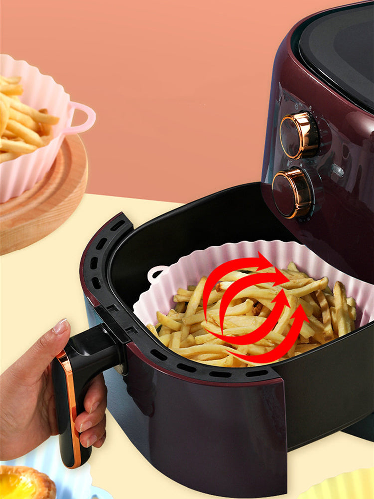 Silicone liner inside an air fryer basket with chips