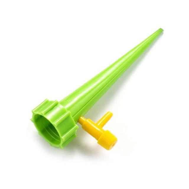 Adjustable self-watering spike attached to an upturned plastic bottle in a plant pot