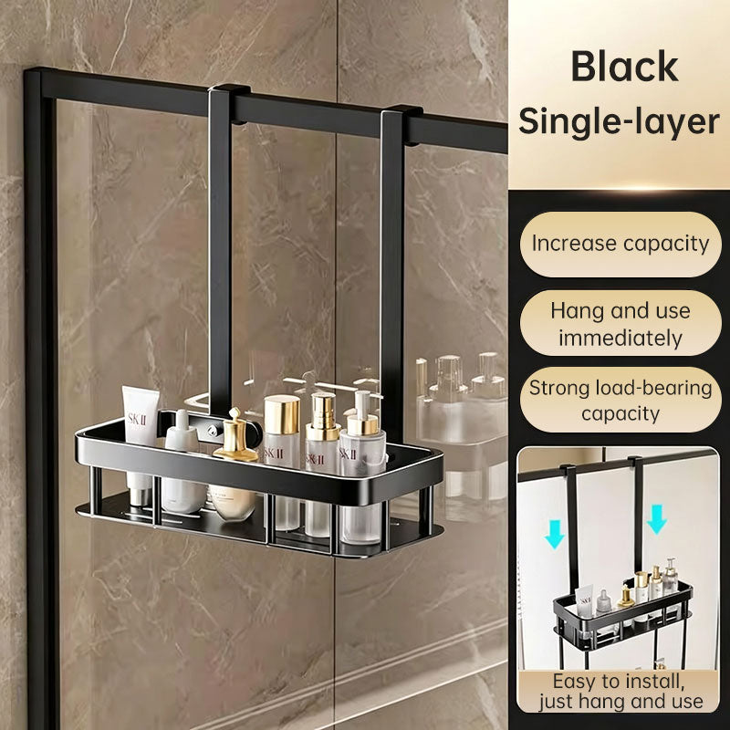 Black single layer no-drill shower caddy hanging over a glass shower screen