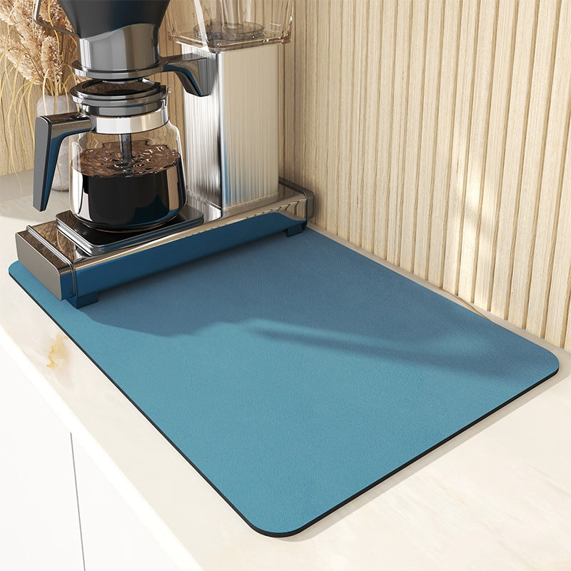 Teal blue draining mat under a coffee machine