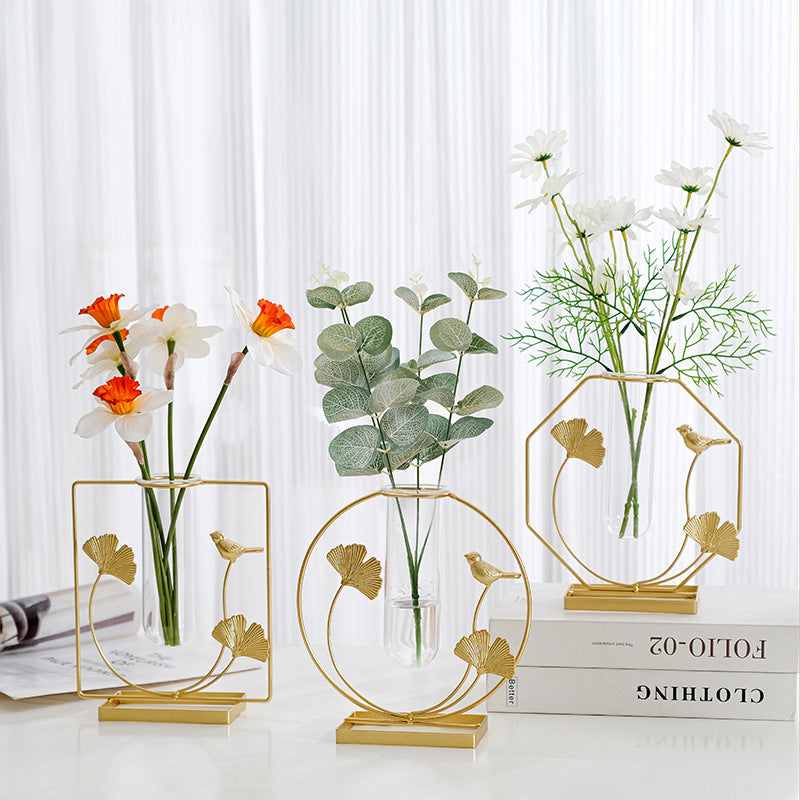 Gold ginkgo leaf and bird metal frame with a clear glass bud vase