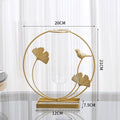 Gold ginkgo leaf and bird metal frame with a clear glass bud vase