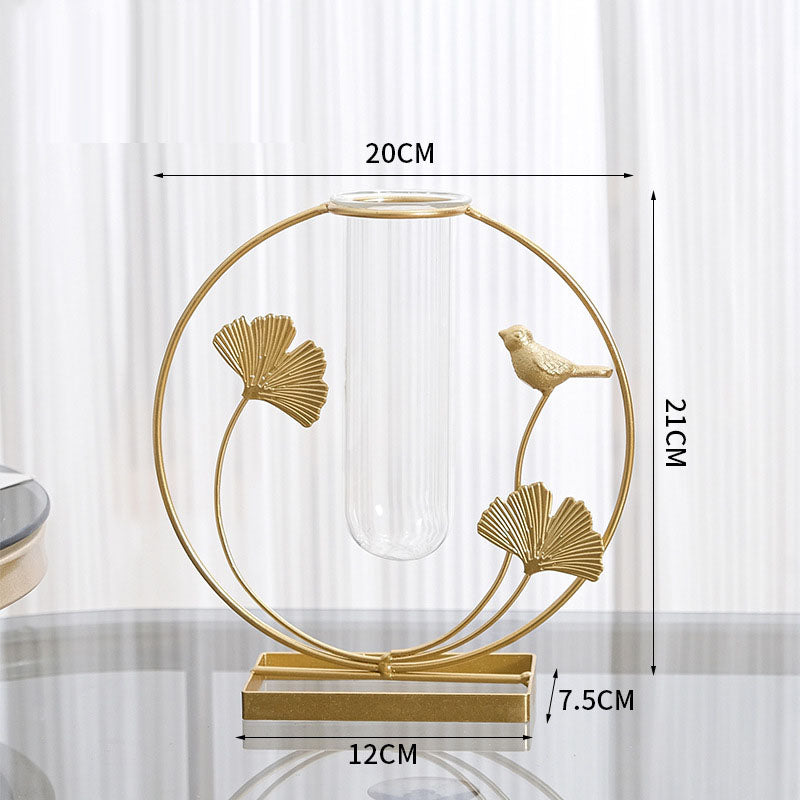 Gold ginkgo leaf and bird metal frame with a clear glass bud vase