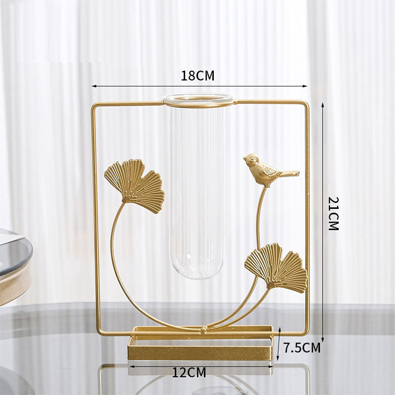 Gold ginkgo leaf and bird metal frame with a clear glass bud vase