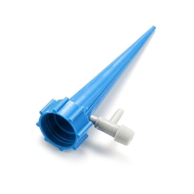Adjustable self-watering spike attached to an upturned plastic bottle in a plant pot