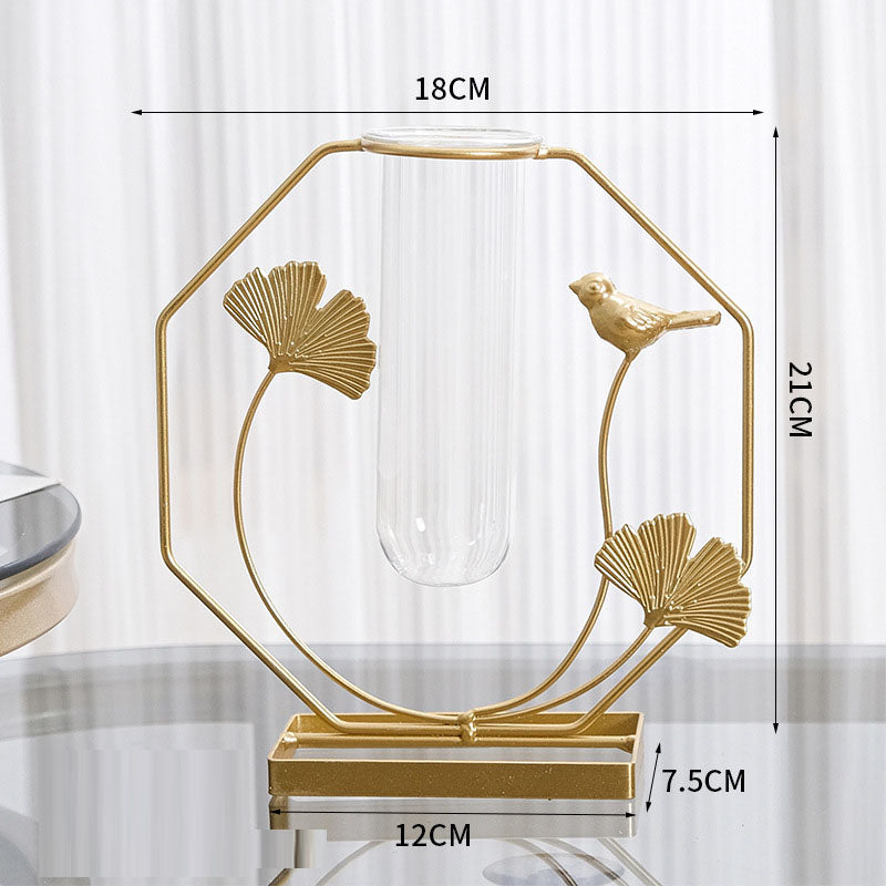 Gold ginkgo leaf and bird metal frame with a clear glass bud vase