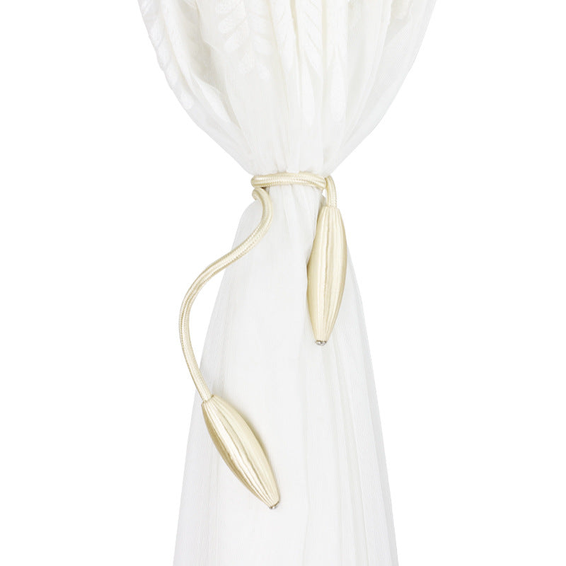 Twisted rope curtain tieback holding a white curtain