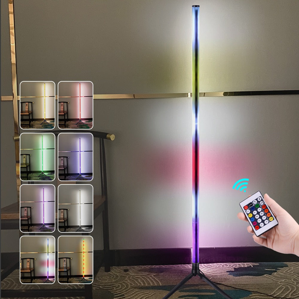 Slim RGB LED corner floor lamp on a tripod stand glowing in colour