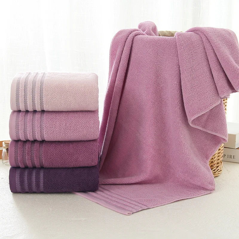 Striped cotton towels in blush pink, lilac, mauve and plum