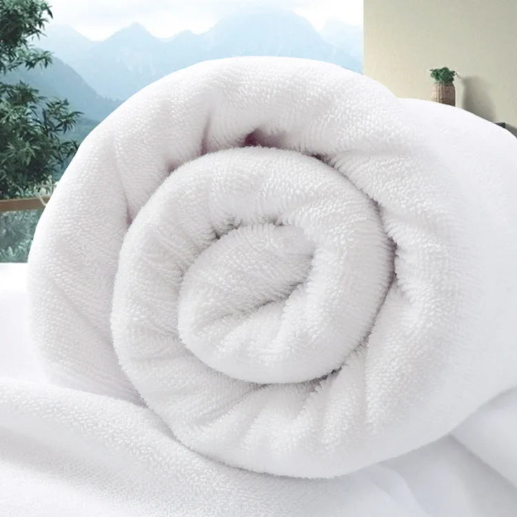 Large white cotton bath towel rolled up