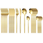 All 24 pieces of the gold cutlery set laid out